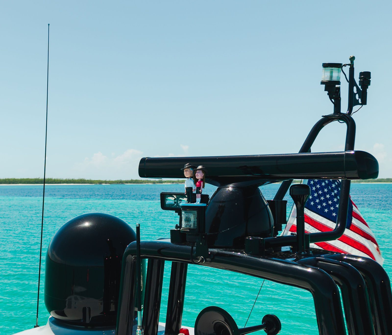KayDee flybridge flag over turquoise Bahamas water