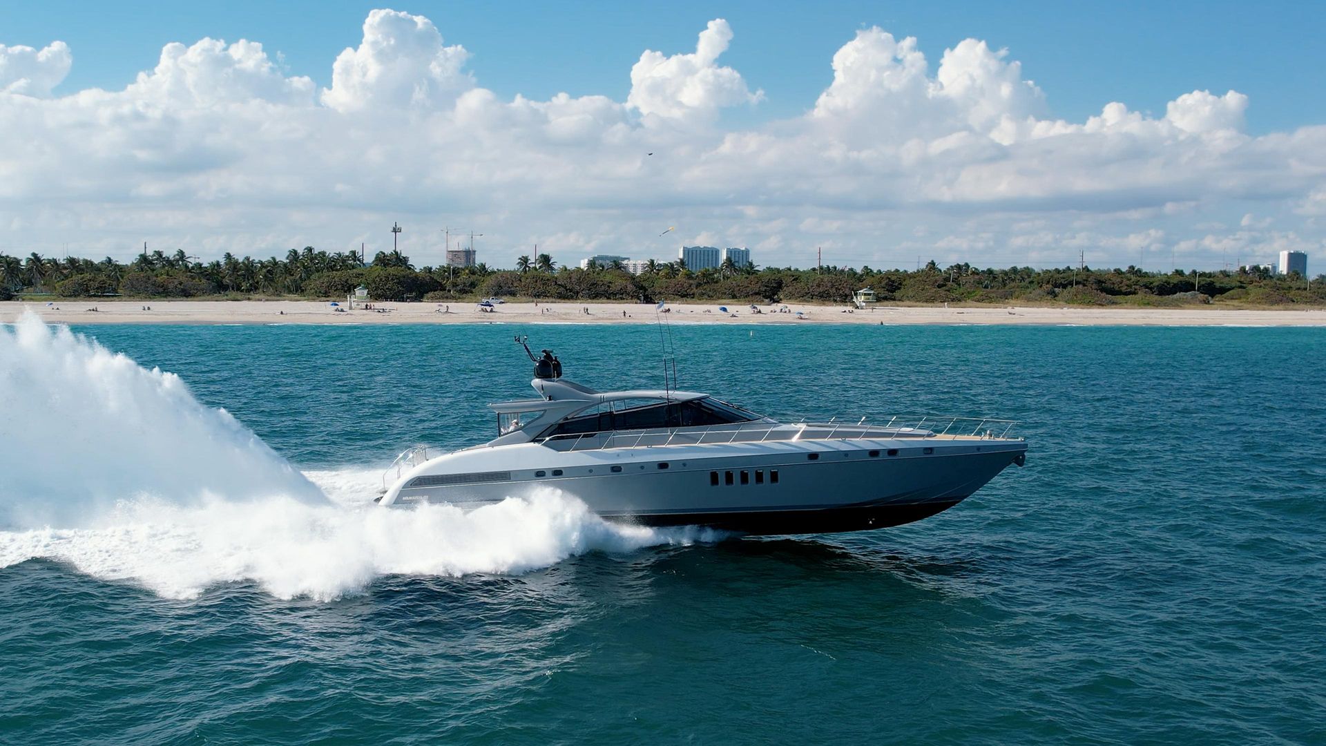KayDee Mangusta 80 at speed skyline behind private yacht charter Nassau