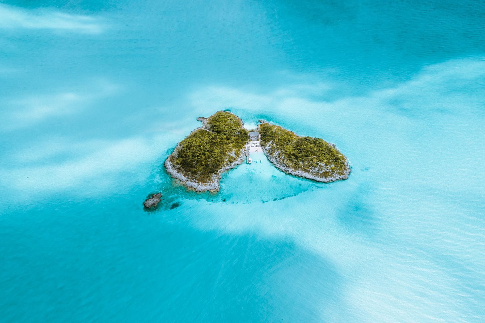 Aerial view of a cay surrounded by turquoise water in the Bahamas